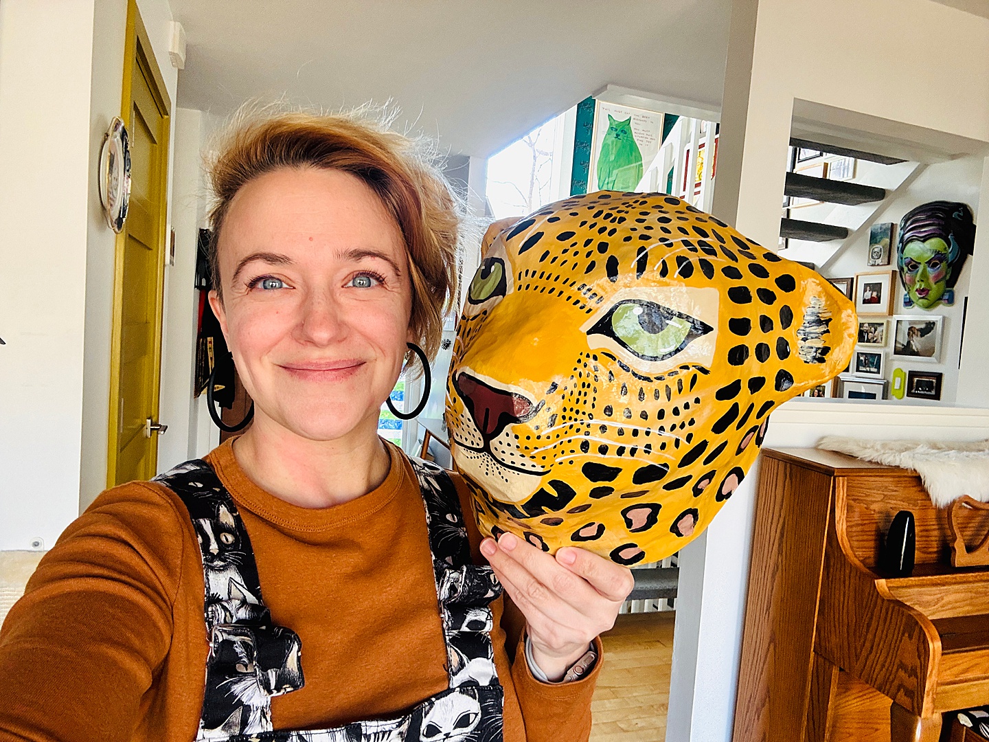 artist holding paper-mache leopard head